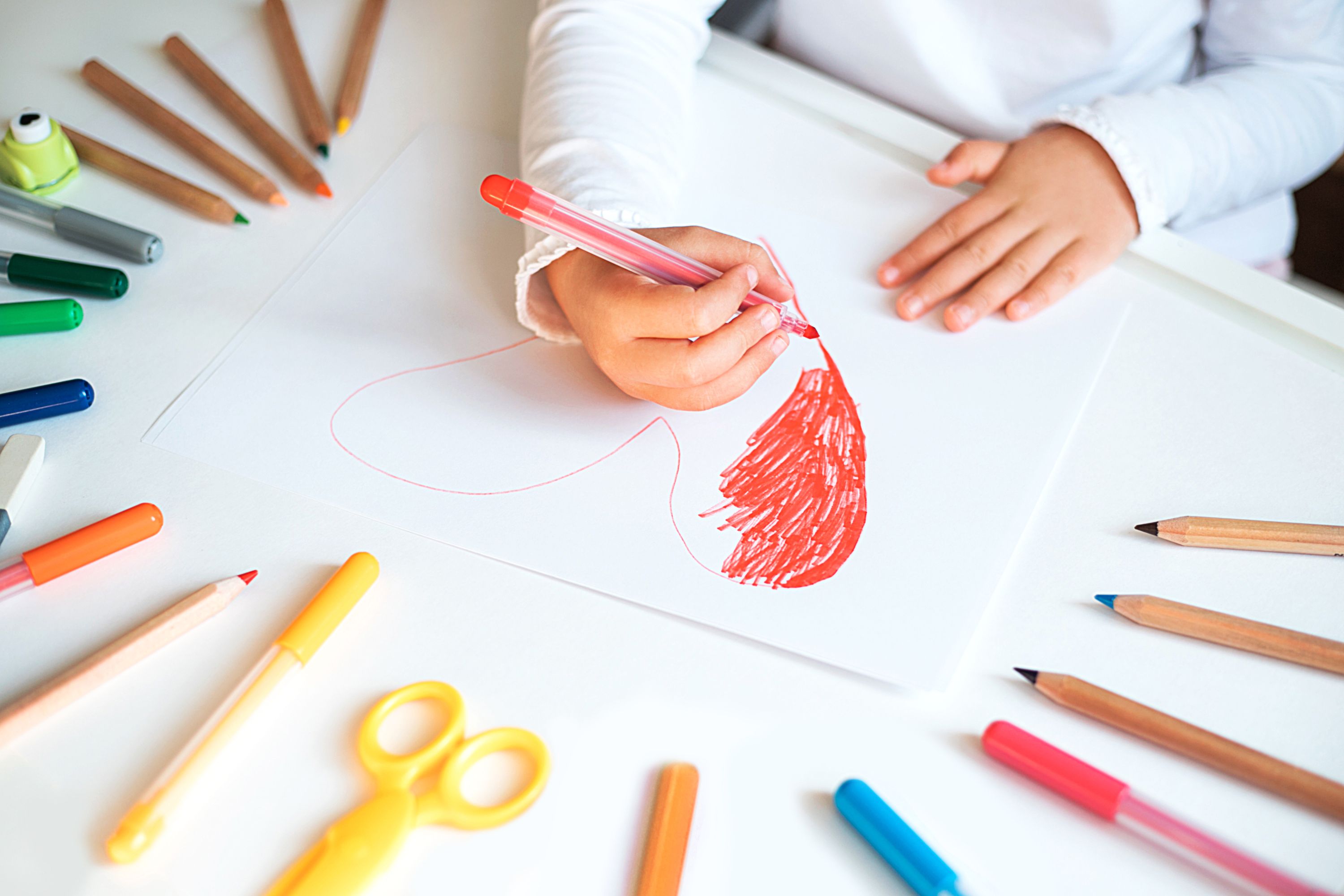 A child colouring in a heart