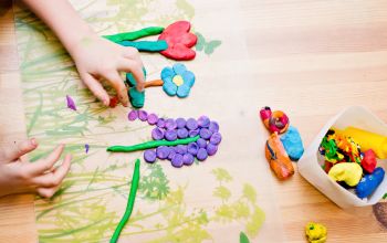 Child making flowers out of plasticine